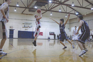 Senior guard Caleb Brown shoots for two against Grace Academy’s Jay Lee. Brown had eight points