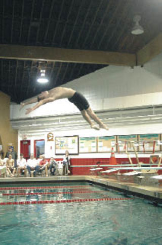 Freshman Tyler Russell dives head first into the pool.