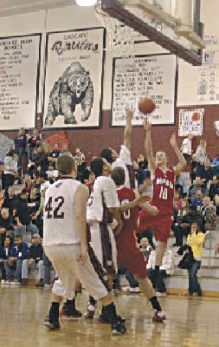 Tomahawk guard Tyler Holm shoots from three-point range. The Tommies trailed Cascade entering the fourth quarter and Holm came up big for his team