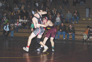 Senior Jason Mueller fights hard against King’s Caleb Smith. Mueller would eventually lose the match by a 7-5 decision.