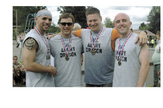 The local division champion team the Angry Dragons poses with their hardware after their win is announced. Pictured