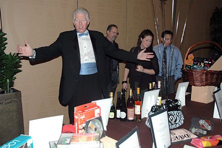 Senior Legacy Auction announcer Kip Toner touts the selection of silent auction items at the Tulalip Resort Hotel and Casino March 14.