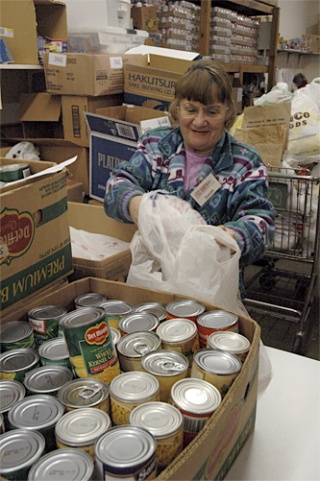 Susan Wakeman helps out Nov. 20 as the Marysville Community Food Bank prepares to hand out more than 900 Thanksgiving food baskets to local families.