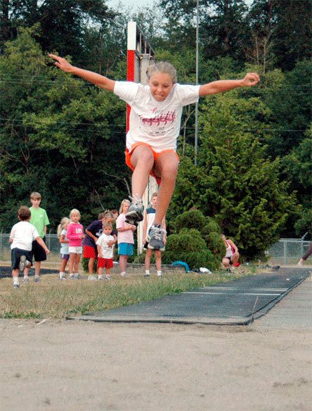 Gabby Grandbois gets good height as she leaps into the pit for the long jump competition.