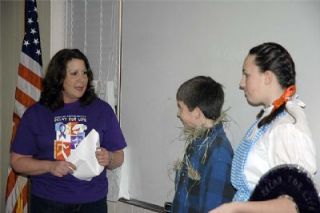 Relay for Life organizing committee member Toni Matthews helps the Scarecrow (Kyler Jacobs) and Dorothy (Kaitie Jacobs) navigate through the Relay for Life.