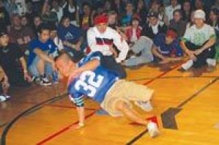 Its mano-a-mano in the big circle at the Marysville YMCA during the footwork battle at the 360 Break Dance Battle on Jan. 26.  Here a competitor watches while a dancer throws it down.