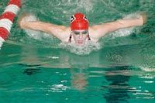 Junior Michaela Caldwell spreads her wings in the 100-yard butterfly Thursday