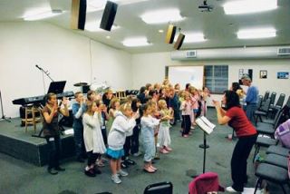 The competing choirs in the Kids For Christ program at Smokey Point Community Church rehearse for their Dec. 9 play