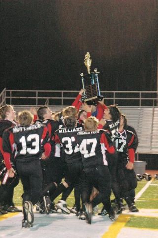 The Marysville Bears all try to get a paw on the championship trophy they won in a 26-13 game against the Bruins.