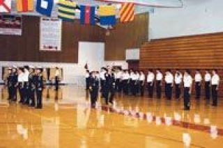 U.S. Navy Rear Admiral Bill Goodwin salutes Marysville-Pilchuck High Schools Tomahawk Company during the 12th Annual Pass-in-Review ceremonies on Nov. 8.  The NJROTC unit is commanded by Lt. Cmdr. Joanna Iglesias