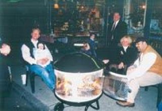 David Boulton serves hotdogs to his guests