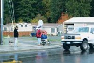 Lakewood locals watch as traffic speeds by on 27th Avenue NE next to the new Target store at the Lakewood Crossing shopping center. From left are Elwood Corulli