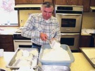 Walt Ames rices potatoes for lefse at Peace Lutheran Church. Ames is one of several guys who spent three  days working with the lefse crew Oct. 16 -18.