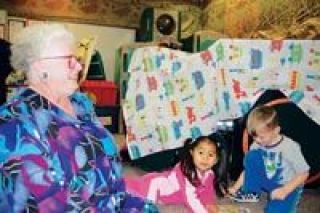 Arlington resident Rita Hunter works with a pair of four-year-old pre-school students in her Liberty Elementary School classroom in Marysville. From left are Hunter