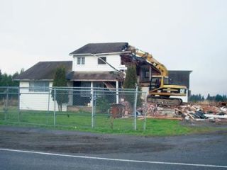 Contractors demolish a house on 67th Avenue NE next to Kellogg Marsh Elementary School in Marysville last week.  The property will eventually host a Christian school.