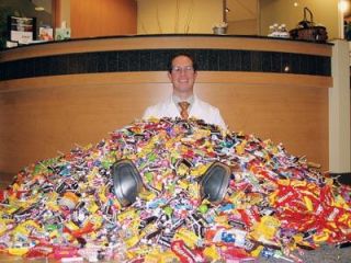 Marysville and Lake Stevens orthodontist Dr. Jason Bourne is covered by 750 pounds of candy which he gave to Mary Welsh