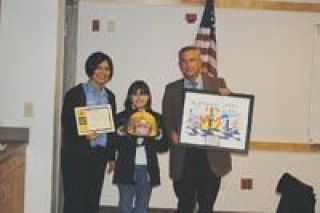 Cascade Elementary School fourth-grader Shayleen Aubert-Bressler is the winner of the Marysville Fire Districts Watch What You Heat safety poster contest.  She won lunch with some MFD firefighters at her school and got a personalized helmet from the Fire Chief Greg Corn at the districts Dec. 20 board meeting.   From left here are Public Information Officer Stephanie Price