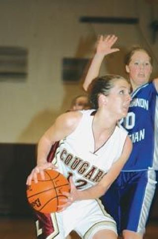 Junior Aly Stewart battles for position as Mt. Vernon Christians Stephanie Geertsma stands her ground Friday
