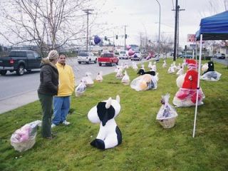 Bobby Costello sells baskets full of chocolates and stuffed animals along Smokey Point Boulevard Tuesday