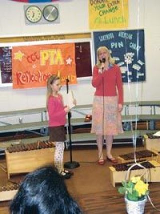 Marli Bartness presents one of two awards to Rachel Alfred during Lakewood School Districts National PTA Reflections Arts Recognition Program.