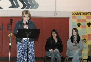 School Principal Judy Albertson led what officials dubbed a commitment assembly at the school last week. Joining her for part of the program were students Chelsea Harbo and Farrah Wolgamott.