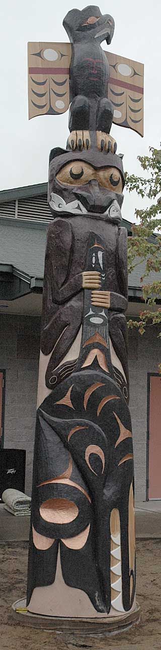 The finished story pole features images of an eagle