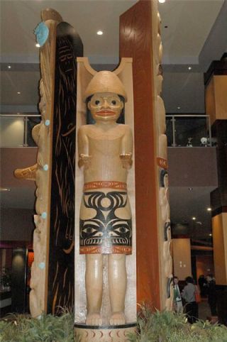 This figure greets visitors to the new Tulalip Resort Hotel. Two story poles flank the figure.