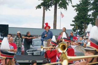 The brass marches past as Tulalip Tribal Chairman Mel Sheldon Jr. watches the Marysville Junior High School Marching Band play during the June 23 Tulalip Parade.