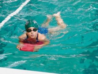 Jessica Booth uses a float board during Marlins swimming practice at the M-P High School pool.