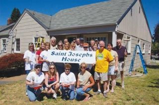 Volunteers from the Everett Windermere Property Management office take a break during their community service day July 6 at Saint Josephs House.  About 30 workers painted and landscaped at the Marysville clothing bank.