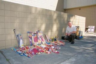Marysville Police Commander Ralph Krusey displays some of the hundreds of confiscated fireworks seized by police during the Fourth of July holiday. The department responded to 153 complaints