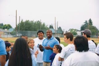 Seattle Seahawk fullback Mack Strong chats with native teens during the Team-Works Sports and