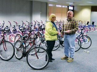 One of Lillie Leins passions was working with Operation Marysville Community Christmas. Here she posed with Marysville Rotary president Wayne Zachary in front of scores of bicycles given to needy kids.