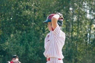 Conner Martinis watches from first base as Mukilteo North warms up their relief pitcher in the top of the sixth inning.
