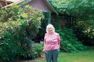 Ione Carlson stands in the yard of the place she has called home for 71 years.  The 96-year-old moved to Marysville in 1936 and has lived in the same house ever since.