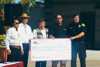 The Tulalip Tribes celebrate a generous donation to the Marysville Police Department with a check for $75