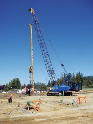 A construction crew from McDowell Northwest uses a huge crane to bore one of 257 holes into the ground last week at the site of the Marysville School Districts new elementary school. Each one of the 60-foot-deep holes will be filled with a rebar cage and concrete to create hundred of stilts to support the slab floor in case of an earthquake.