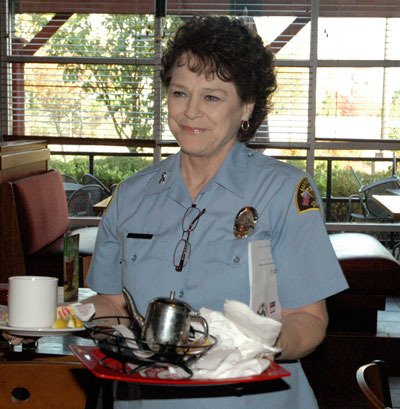 Marysville Police Department programs specialist Vicky Nyman buses tables for Tip-A-Cop at the Lakewood Red Robin on Oct. 12.