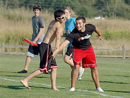 Marysville-Pilchuck senior Cole Cushing tosses the frisbee to a teammate as the cross country team cools down from an afternoon of training at Strawberry Fields.