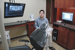 Dr. Whan Mike Cho uses technology such as ceiling-mounted monitors to show his patients their own X-rays electronically.