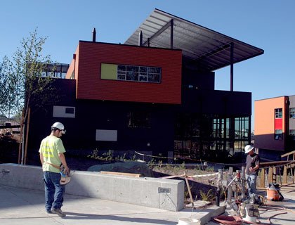 Construction crews work on the walkways leading to Marysville Getchell High School’s new Academy of Construction and Engineering building on Aug. 24.