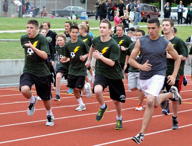 Runners take off at the start of the Juan Mendoza Memorial Mile on June 1 at the Marysville Getchell High School track.