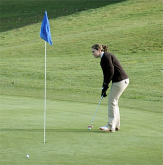 Sophomore Stasia Ashley putts the ball at Cedarcrest Golf Course.