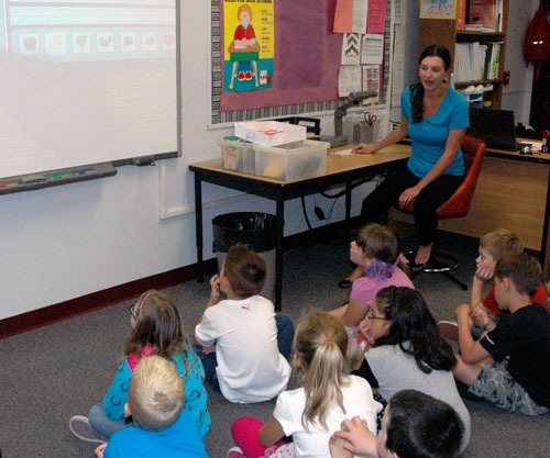 English Crossing Elementary second-grade teacher Lisa Lewis uses a whiteboard projector to teach math to her class on their second day of school on Sept. 4.