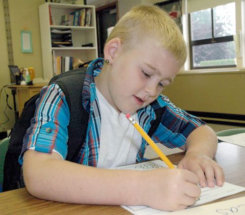 Liberty Elementary first-grader Lucas Walker begins his first assignment in Karen Robinson’s class on the first day of school on Sept. 4.