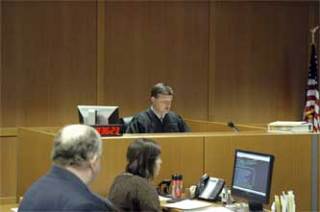 With a bailiff and clerk of courts looking on