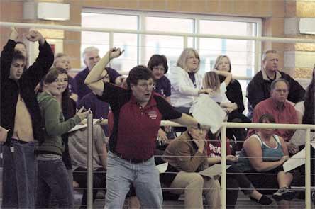 Coach Scott Knowles cheers on Spencer Girard during the 200-yard freestyle race.
