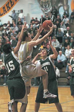 Cougars' senior Beau Wiersma splits a pair of Sehome defenders while going for a layin.