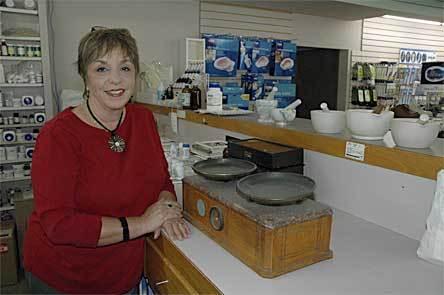 Hilton Pharmacy owner Mary Kirkland shows off some of the antique tools of her store's trade