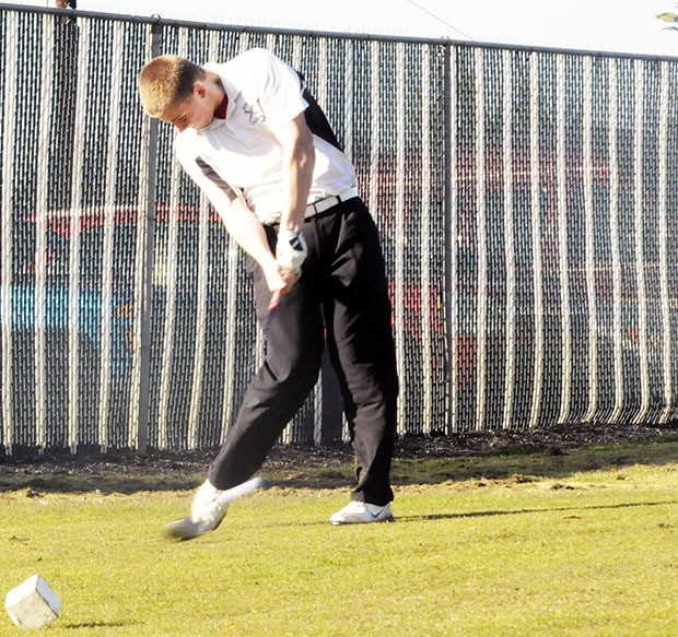 Marysville-Pilchuck golfer practices his swing.